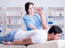female-chiropractor-doctor-massaging-male-patient-female-chiropractor-doctor-massaging-male-patient-159918139